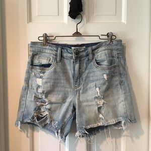 Low rise distressed and ripped denim shorts